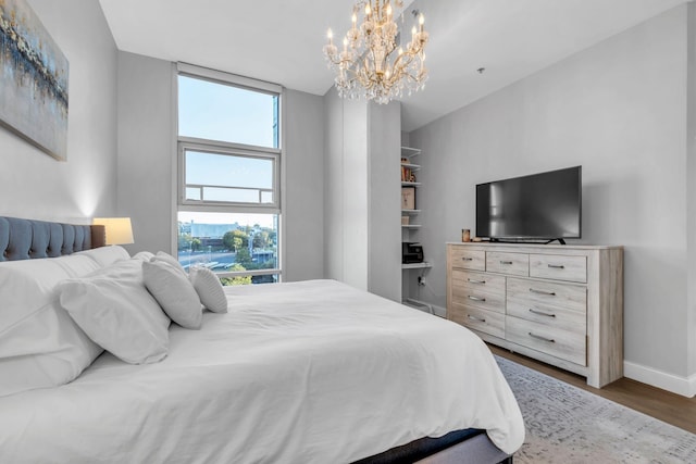 bedroom featuring dark hardwood / wood-style flooring and a chandelier