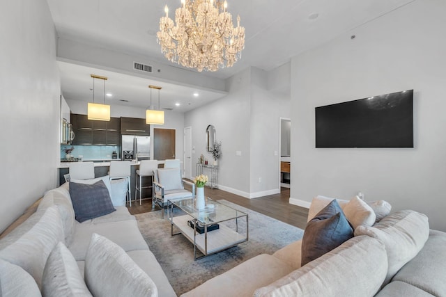 living room with dark hardwood / wood-style floors and a notable chandelier