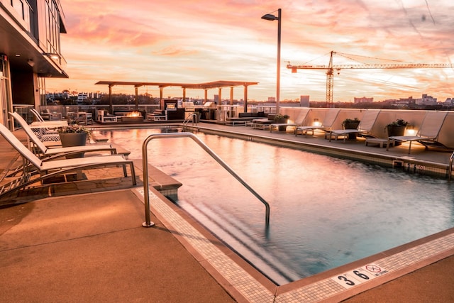 view of pool at dusk