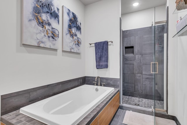 bathroom featuring shower with separate bathtub and tile patterned flooring