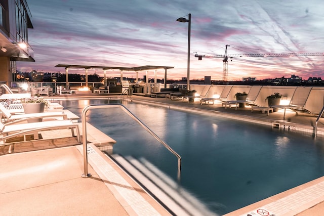 view of pool at dusk