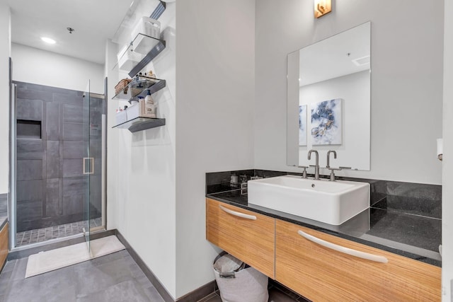 bathroom with a shower with door and vanity