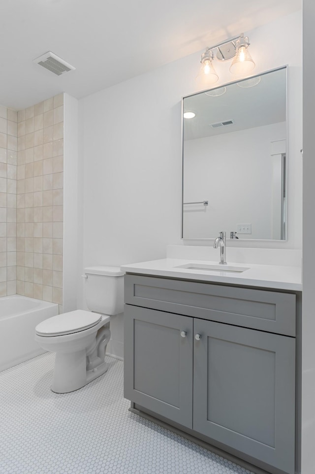 full bathroom featuring vanity, tile patterned floors, toilet, and bathtub / shower combination