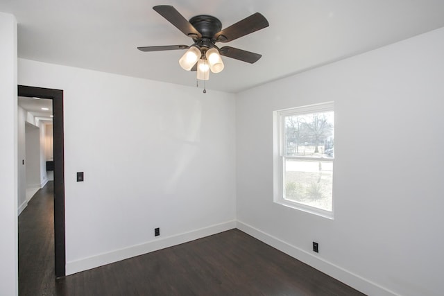 empty room featuring ceiling fan and dark hardwood / wood-style flooring