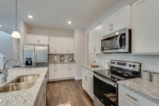 kitchen featuring tasteful backsplash, stainless steel appliances, sink, and white cabinets