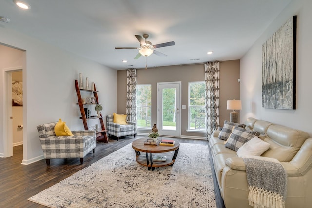 living room featuring dark hardwood / wood-style floors and ceiling fan