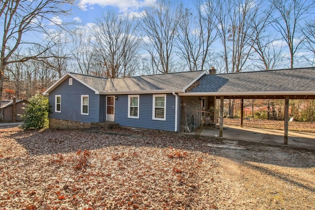 single story home featuring a carport