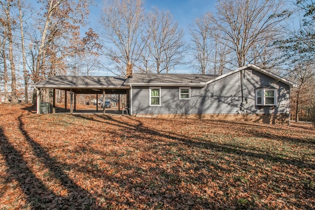 back of house with a yard and a carport