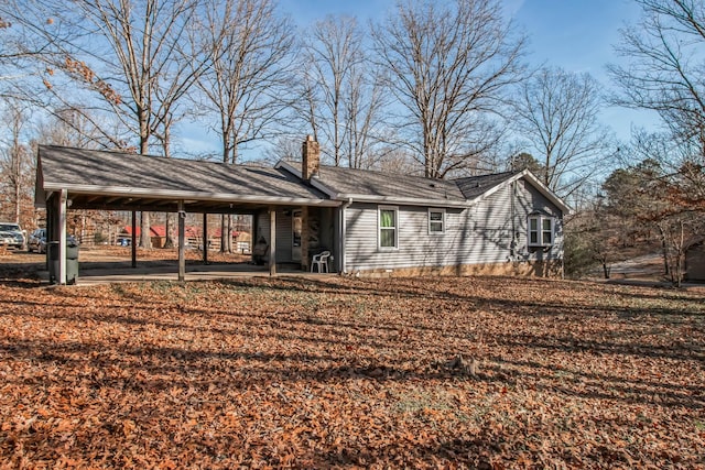 rear view of property with a carport