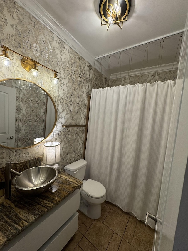 bathroom with vanity, ornamental molding, and toilet