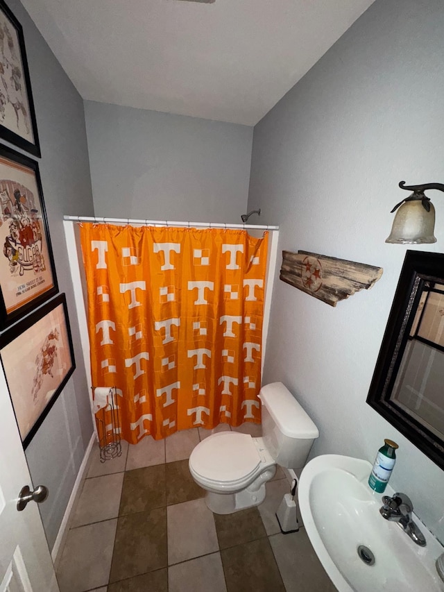 bathroom featuring tile patterned flooring, sink, and toilet