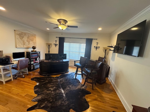 office area with crown molding, wood-type flooring, and ceiling fan