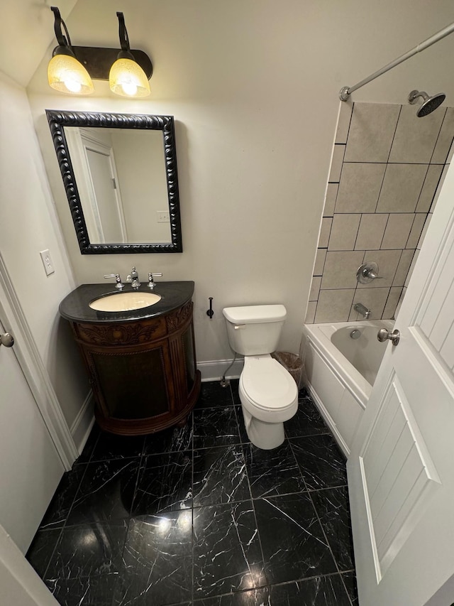 full bathroom with tiled shower / bath, vanity, and toilet