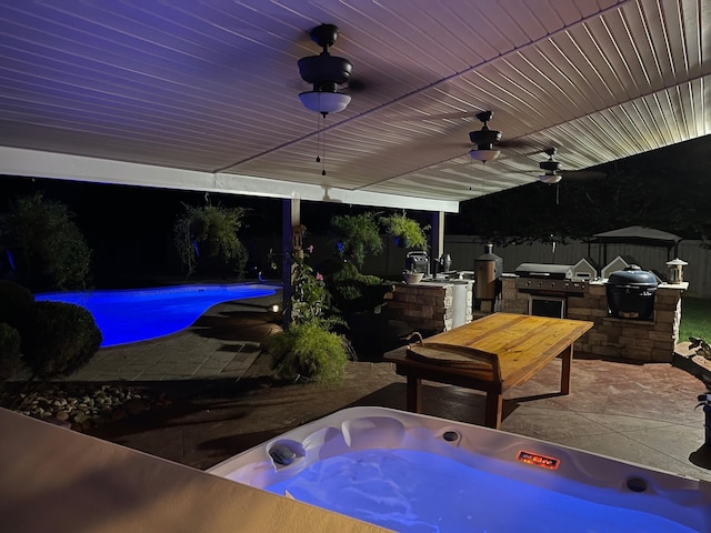 view of patio / terrace featuring a bar, an outdoor kitchen, and grilling area