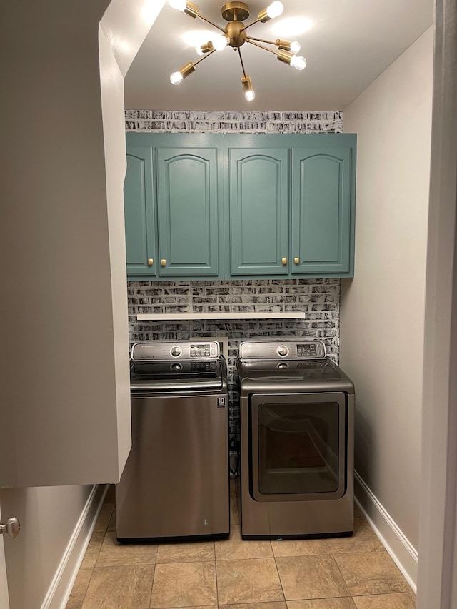 clothes washing area with cabinets, light tile patterned floors, and washing machine and clothes dryer