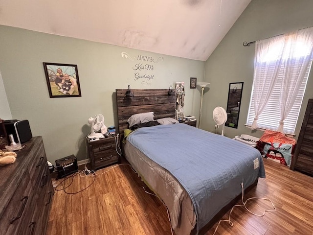 bedroom featuring hardwood / wood-style floors and vaulted ceiling