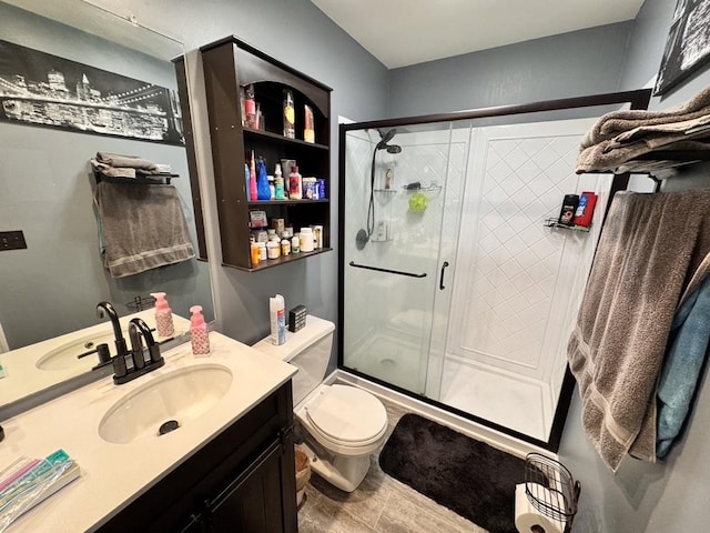 bathroom featuring vanity, toilet, and walk in shower