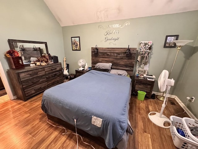 bedroom featuring vaulted ceiling and hardwood / wood-style floors