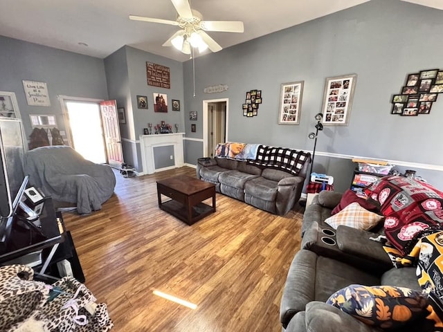 living room with hardwood / wood-style flooring and ceiling fan