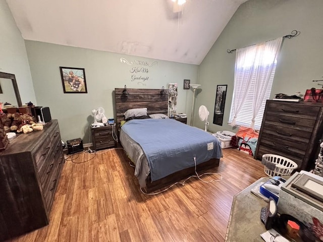 bedroom featuring lofted ceiling and light hardwood / wood-style flooring