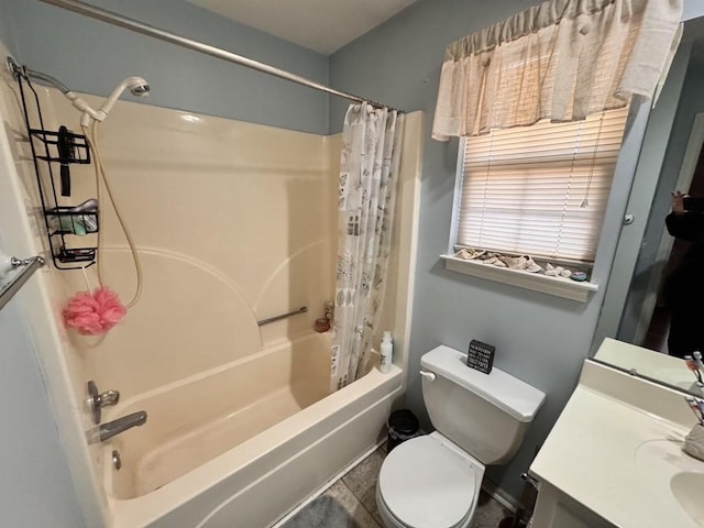 full bathroom with shower / tub combo, vanity, tile patterned floors, and toilet