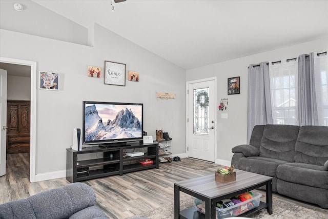 living room featuring lofted ceiling, hardwood / wood-style floors, and plenty of natural light