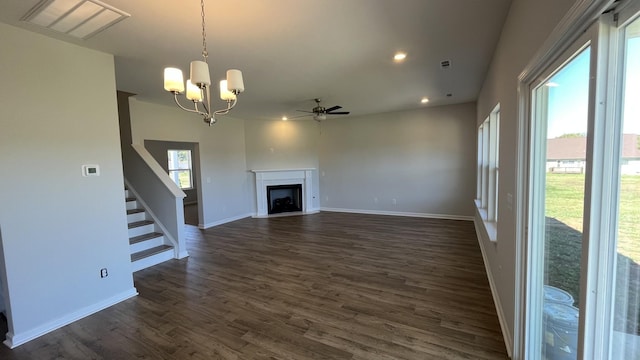 unfurnished living room with dark hardwood / wood-style flooring and ceiling fan with notable chandelier