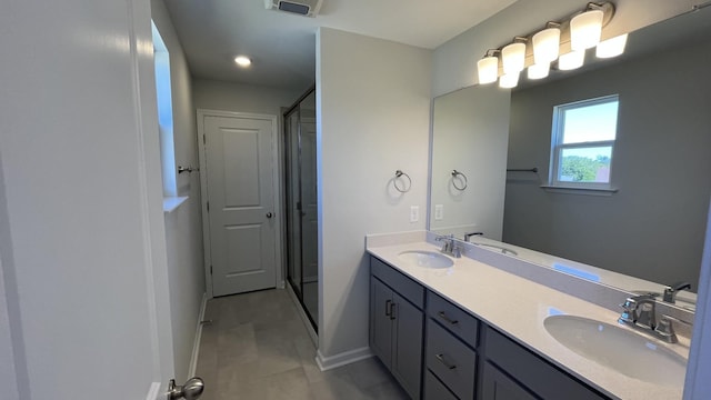 bathroom with walk in shower and vanity