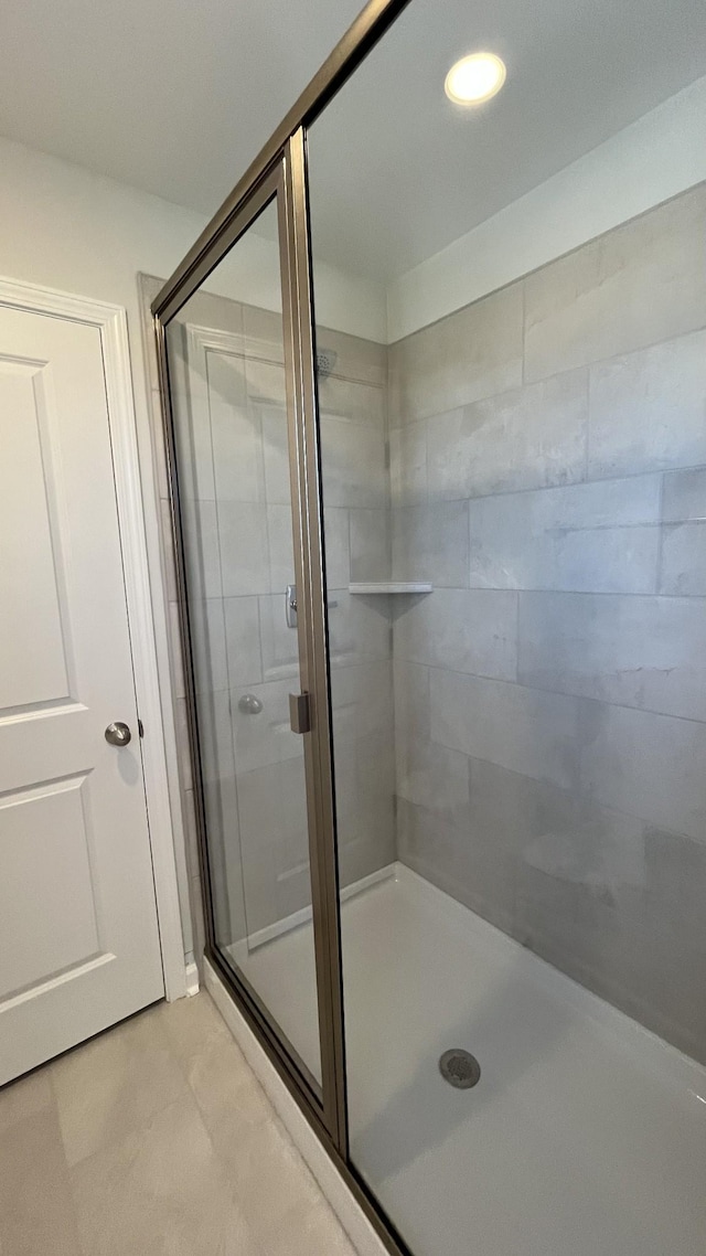 bathroom featuring a shower with door