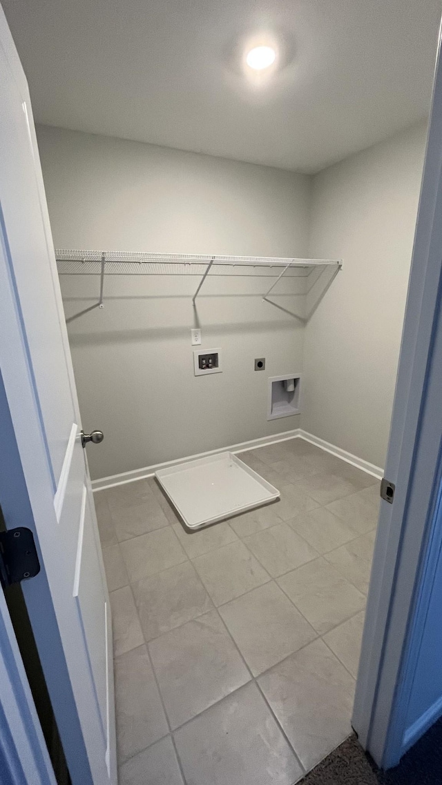 washroom with hookup for an electric dryer, hookup for a washing machine, and light tile patterned floors