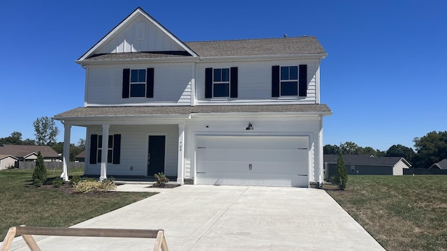 view of property with a garage, a front yard, and covered porch