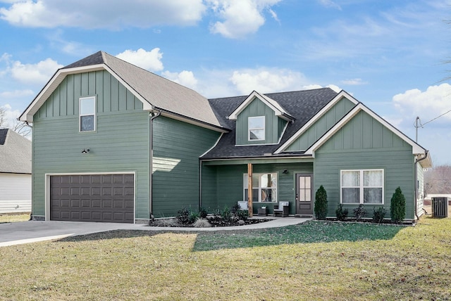 view of front of property featuring a garage, a porch, a front yard, and cooling unit