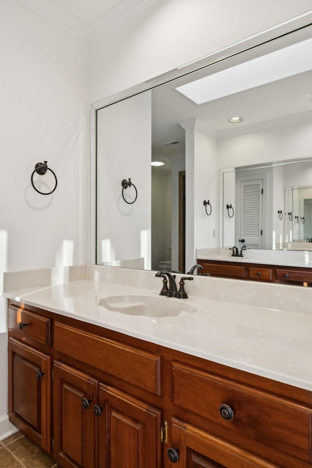 bathroom featuring vanity, tile patterned flooring, and crown molding