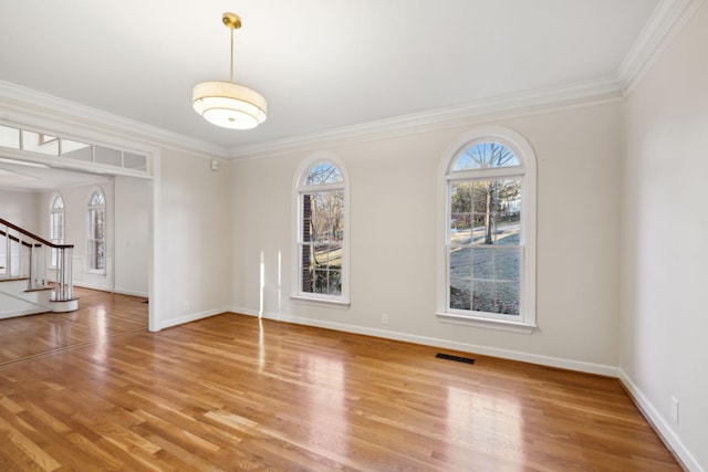 unfurnished room with ornamental molding and hardwood / wood-style floors