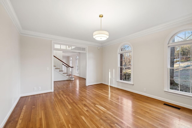 interior space with wood-type flooring, a healthy amount of sunlight, and crown molding