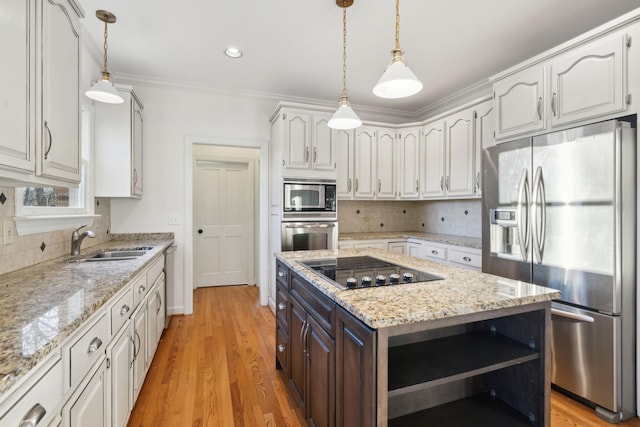 kitchen featuring stainless steel appliances, decorative light fixtures, sink, and white cabinets