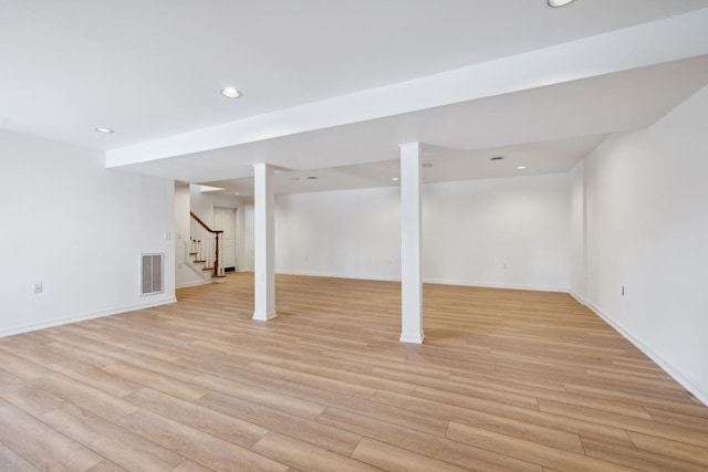 basement with light hardwood / wood-style flooring