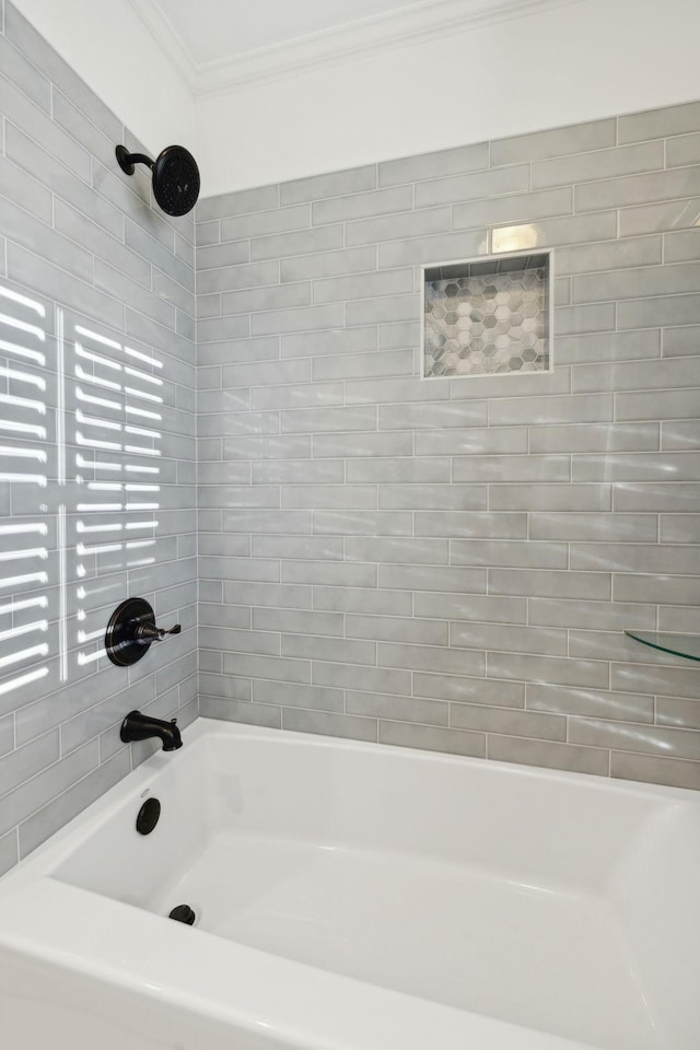 bathroom featuring tiled shower / bath and ornamental molding