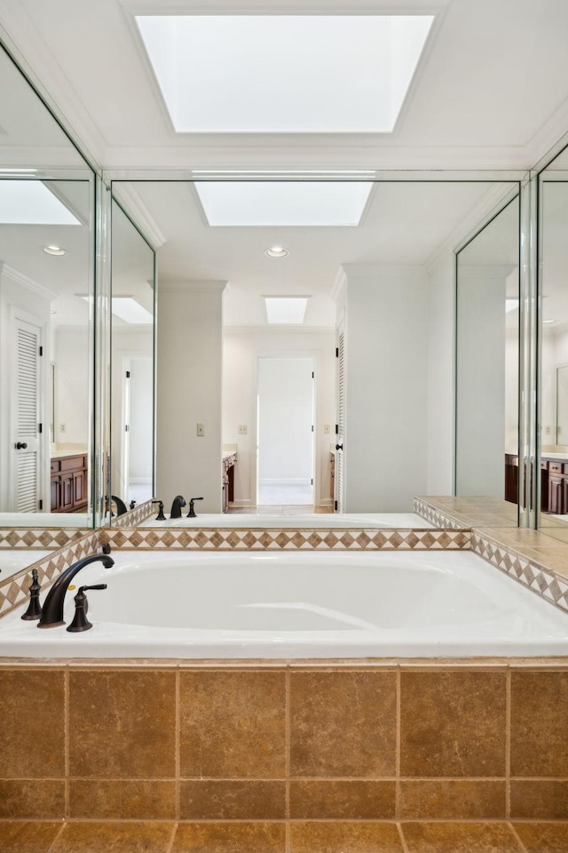 bathroom featuring tiled bath and a skylight