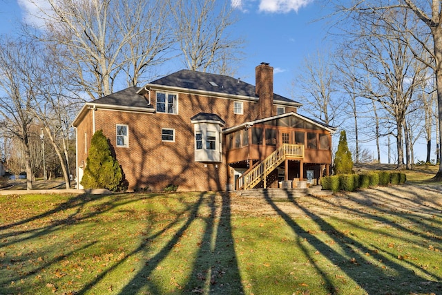 rear view of property with a sunroom and a lawn