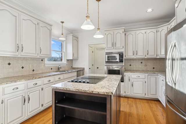 kitchen with appliances with stainless steel finishes, hanging light fixtures, and white cabinets