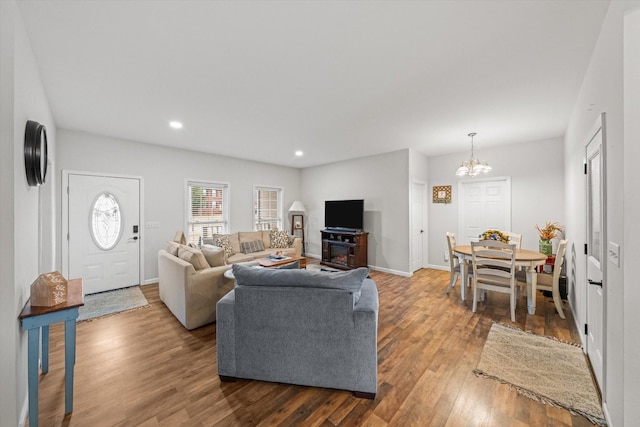 living room with hardwood / wood-style floors and a notable chandelier