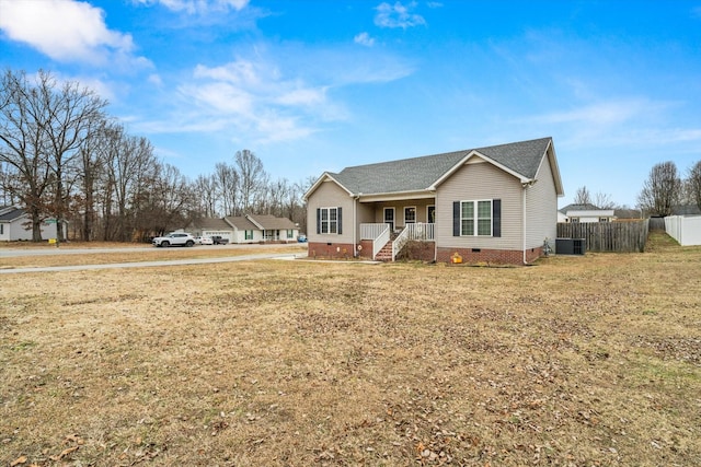 view of front of house with central AC unit, covered porch, and a front yard