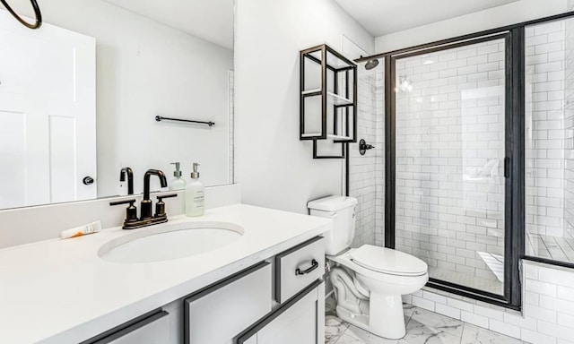 bathroom featuring vanity, toilet, and a shower with shower door