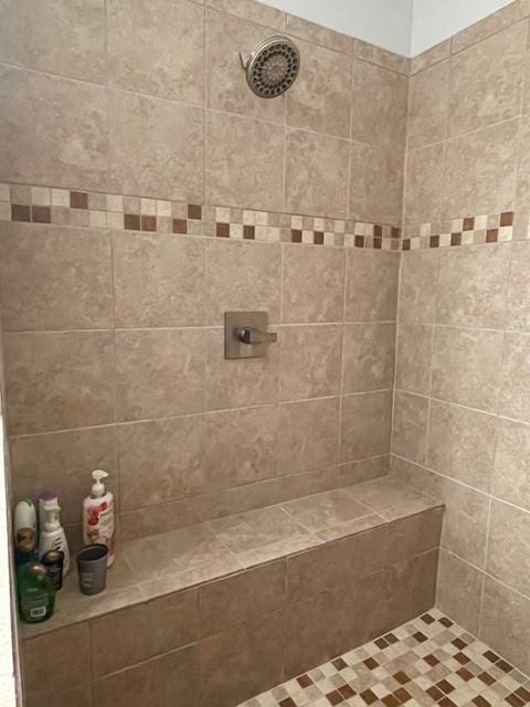 bathroom with tiled shower