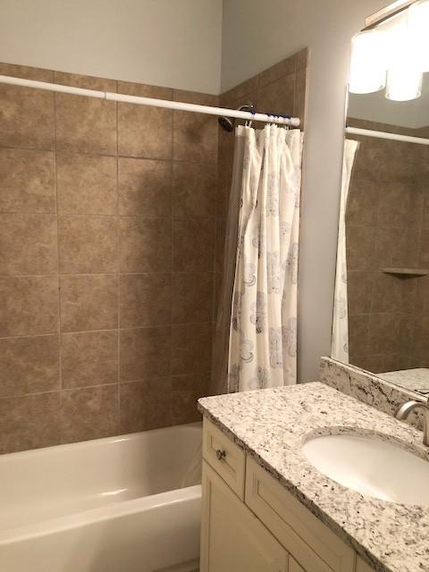 bathroom featuring vanity and shower / tub combo with curtain