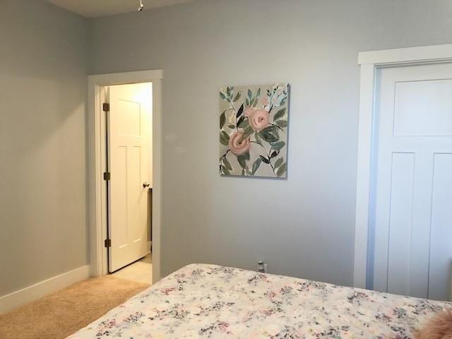 bedroom featuring light colored carpet