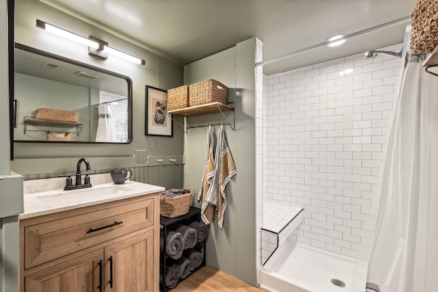 bathroom with walk in shower and vanity