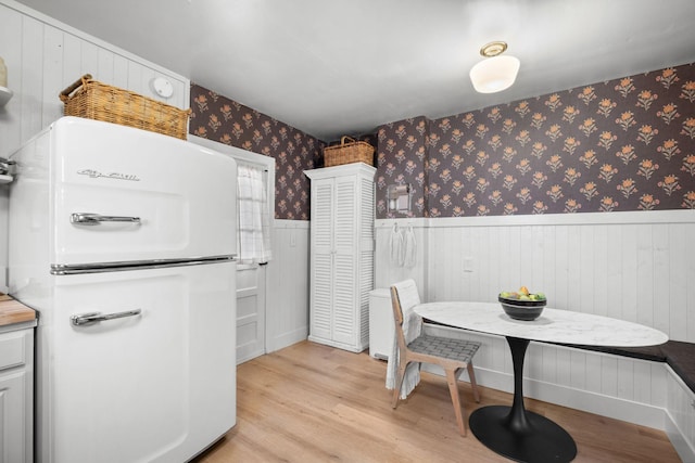 dining area featuring breakfast area and light hardwood / wood-style floors