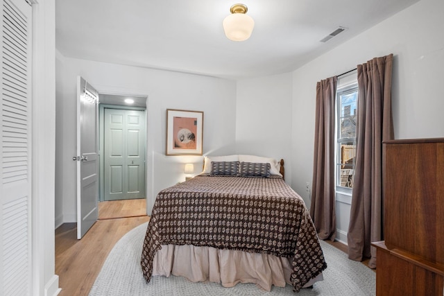 bedroom featuring light wood-type flooring and a closet